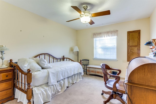 bedroom with ceiling fan and light carpet