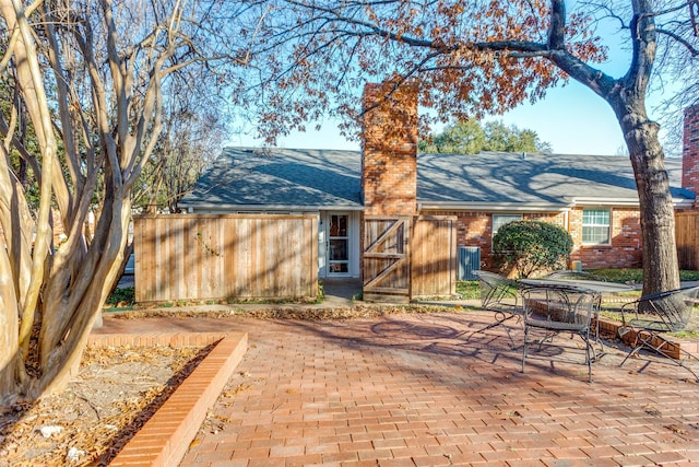 back of house with a patio