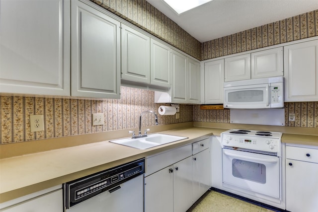 kitchen featuring white cabinetry, white appliances, and sink