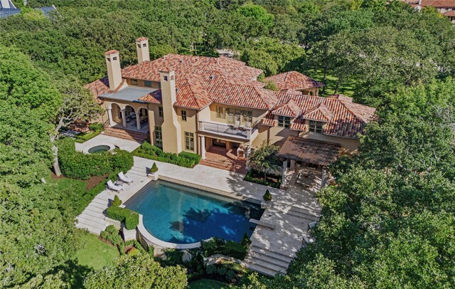 mediterranean / spanish-style home with a balcony and a carport