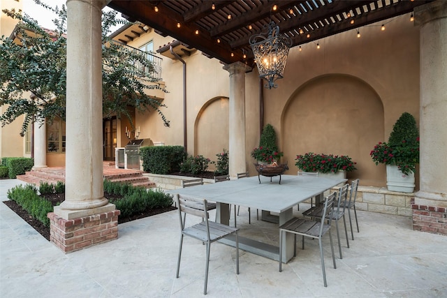 view of patio featuring exterior kitchen, grilling area, and a pergola