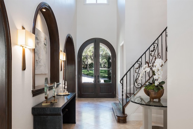 foyer entrance with a high ceiling and french doors