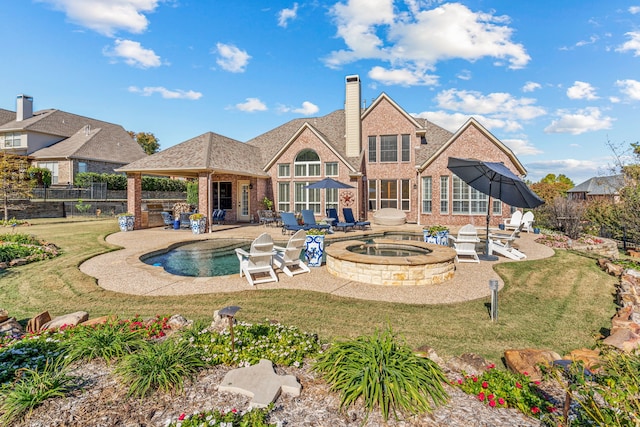 rear view of property featuring a patio, a fenced backyard, brick siding, a yard, and a chimney