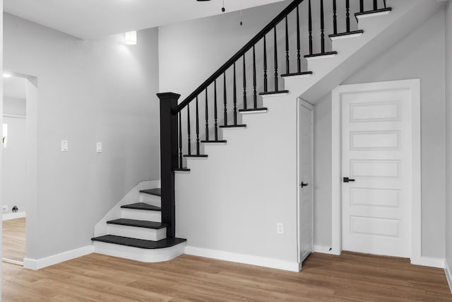 staircase with hardwood / wood-style flooring