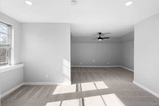 empty room with carpet flooring, ceiling fan, and lofted ceiling