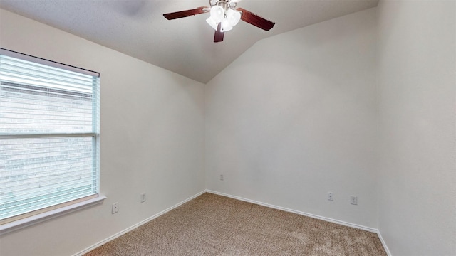 carpeted empty room with ceiling fan and vaulted ceiling