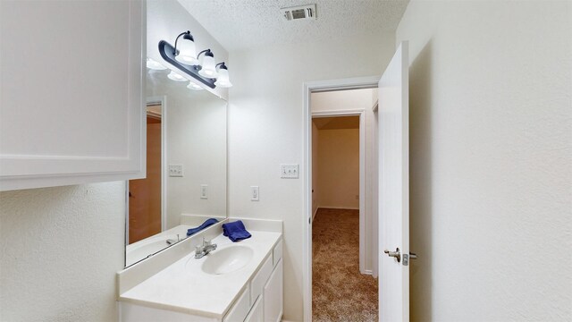 bathroom featuring vanity and a textured ceiling