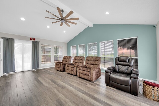 living room featuring vaulted ceiling with beams, light hardwood / wood-style flooring, plenty of natural light, and ceiling fan