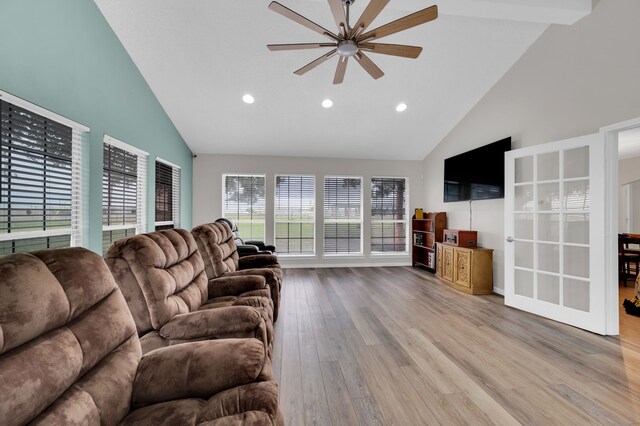 living room featuring light wood-type flooring, high vaulted ceiling, and ceiling fan