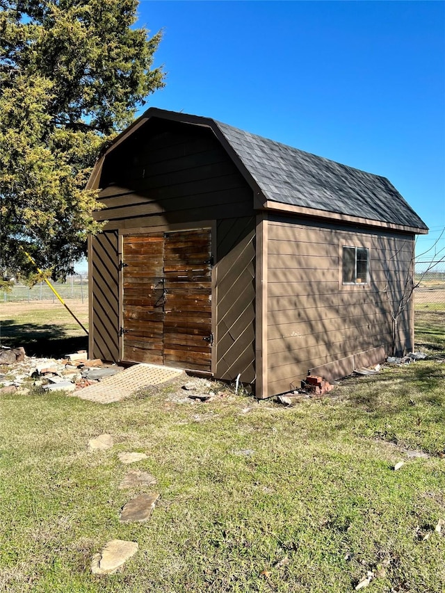 view of outbuilding featuring a yard