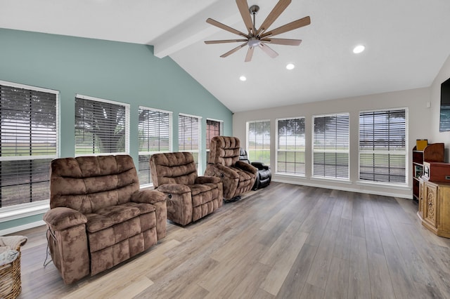 living room with vaulted ceiling with beams, ceiling fan, and light hardwood / wood-style floors