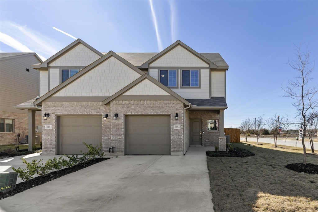 craftsman-style home featuring a garage and cooling unit