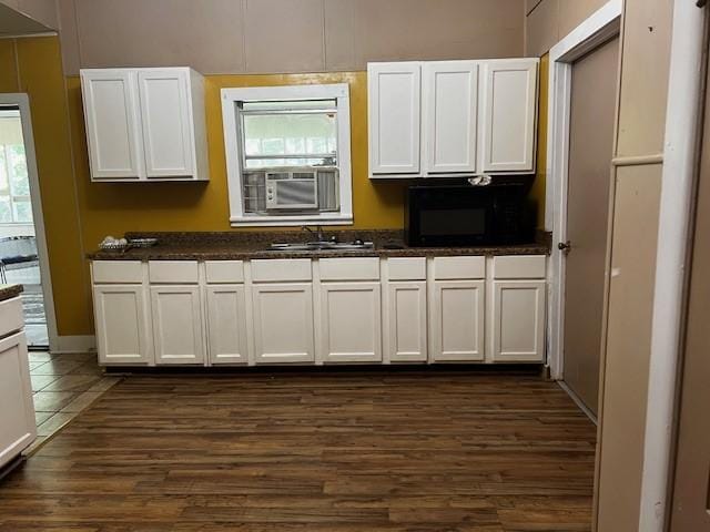 kitchen featuring white cabinetry, sink, and dark wood-type flooring