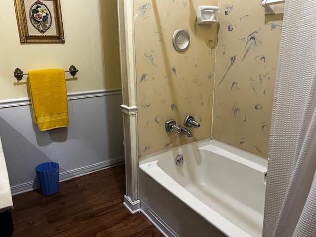 bathroom featuring wood-type flooring and shower / tub combo