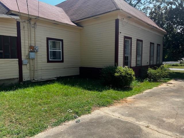 view of property exterior featuring a lawn