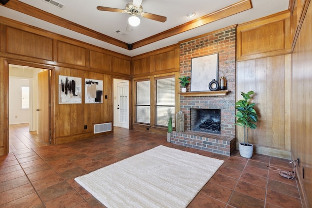 living room with ceiling fan and wood walls