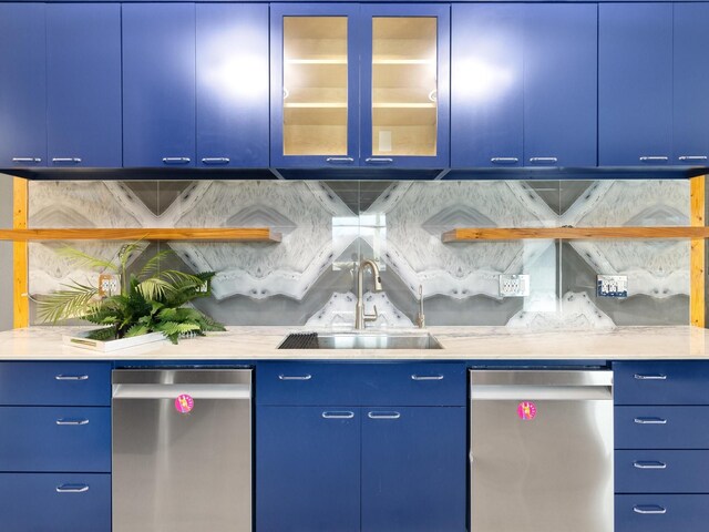 kitchen with wall chimney exhaust hood, blue cabinets, light stone counters, double oven range, and a wealth of natural light