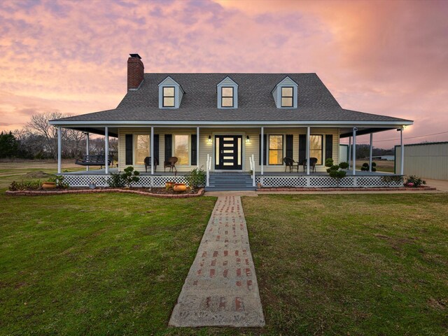 farmhouse inspired home featuring a lawn and a porch