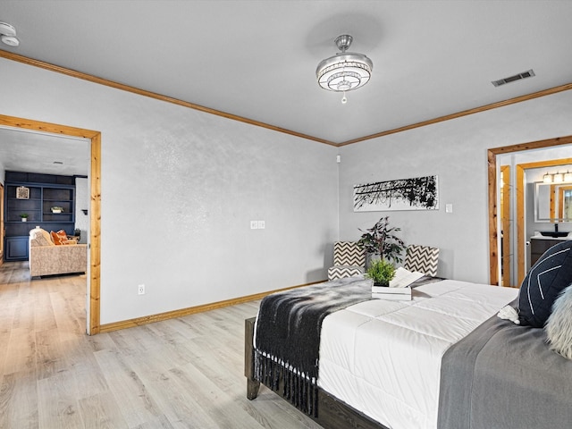 bedroom with baseboards, light wood-type flooring, visible vents, and crown molding