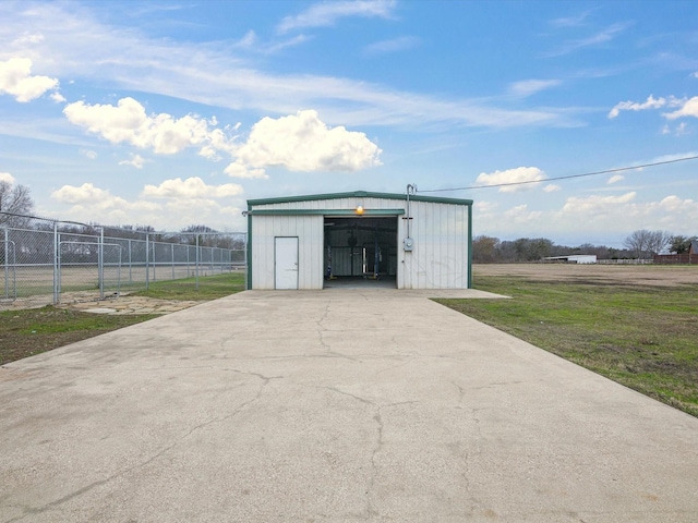 view of outdoor structure with an outbuilding and fence