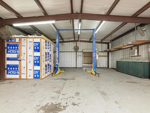 garage with an AC wall unit and metal wall