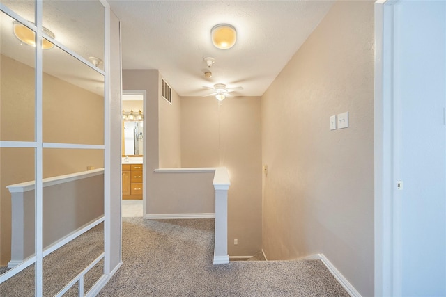 corridor with carpet flooring