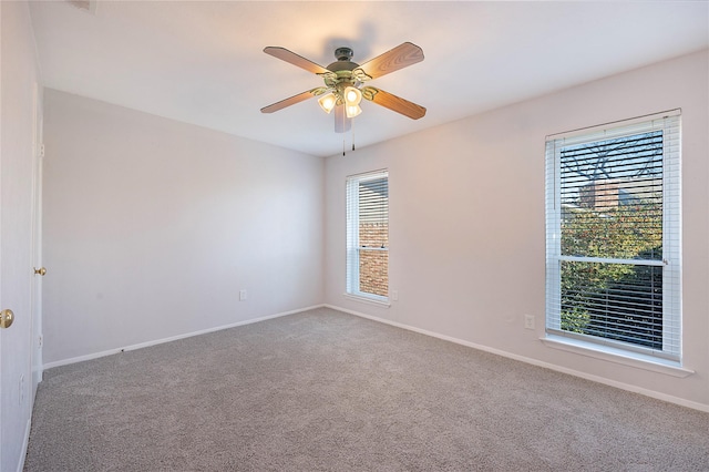 empty room featuring carpet and ceiling fan