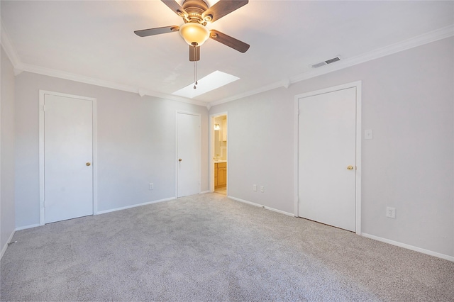 unfurnished room featuring light colored carpet, ceiling fan, and crown molding