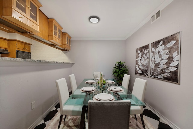 dining room featuring crown molding