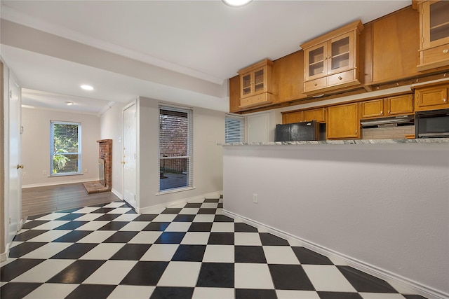 kitchen with crown molding and black appliances