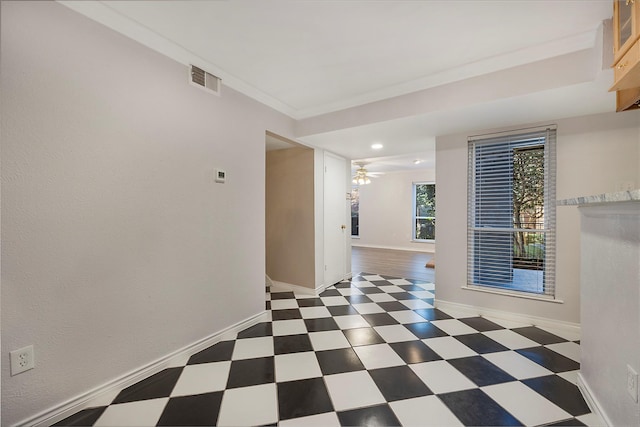 spare room with ceiling fan and crown molding