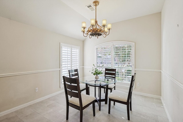 dining space featuring a chandelier, plenty of natural light, lofted ceiling, and light tile patterned flooring