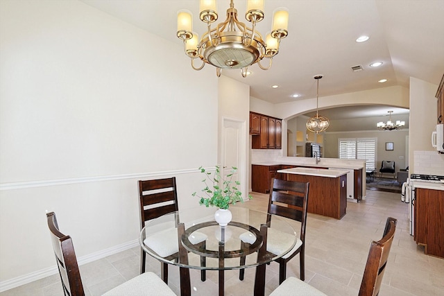 tiled dining space featuring vaulted ceiling and an inviting chandelier