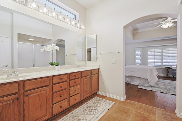 bathroom featuring ceiling fan, tile patterned flooring, vanity, and walk in shower