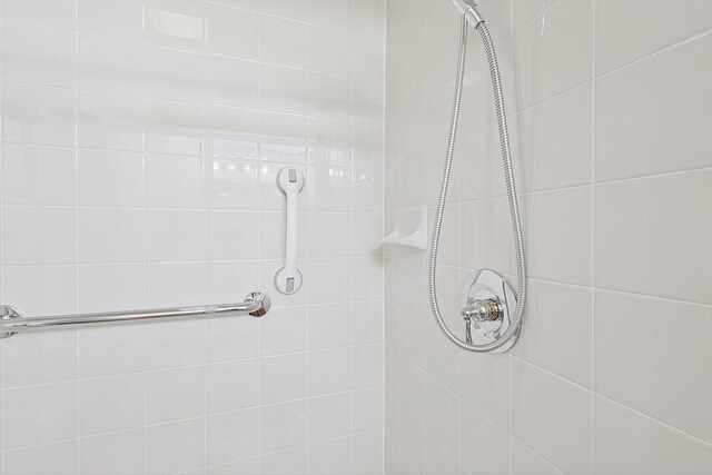 bathroom with tiled shower