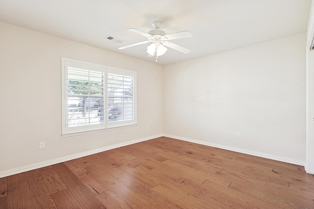 empty room with ceiling fan and light hardwood / wood-style floors