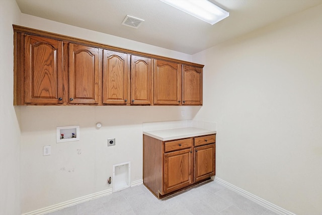 laundry room with hookup for an electric dryer, hookup for a gas dryer, cabinets, and washer hookup