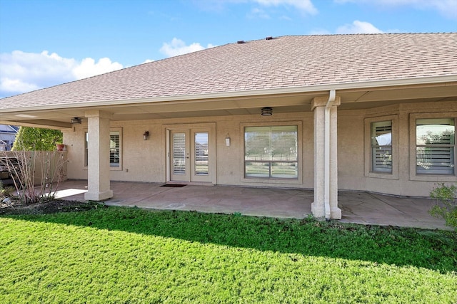 rear view of house with a lawn and a patio