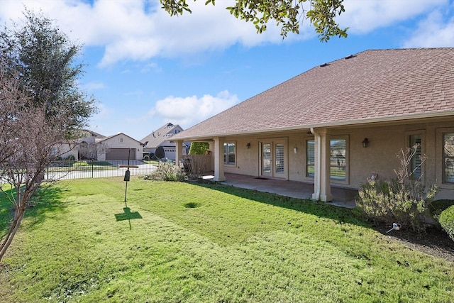 view of yard featuring french doors and a patio area