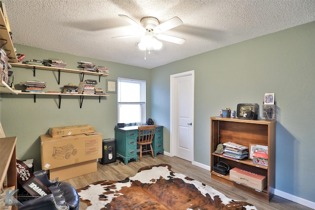 office with ceiling fan, wood-type flooring, and a textured ceiling