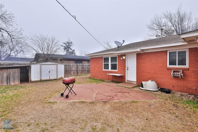 back of house featuring a patio and a shed