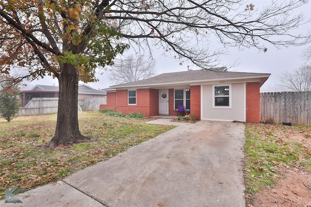 ranch-style house with a front lawn