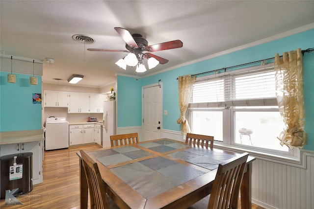 dining area featuring washer / clothes dryer, crown molding, ceiling fan, and light hardwood / wood-style floors