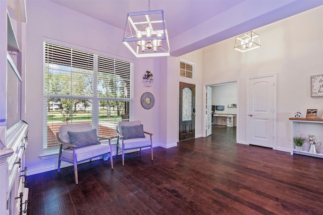 sitting room with dark hardwood / wood-style flooring and a notable chandelier