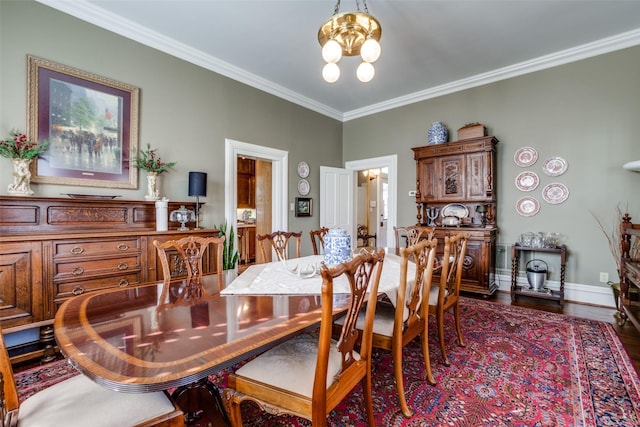 dining area featuring a chandelier, dark hardwood / wood-style floors, and ornamental molding