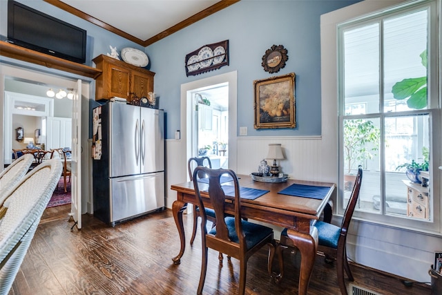 dining space with dark hardwood / wood-style floors and ornamental molding