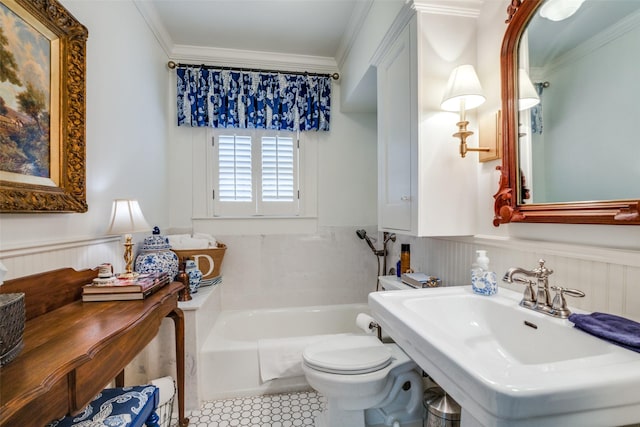 bathroom featuring a tub to relax in, tile patterned floors, crown molding, sink, and toilet