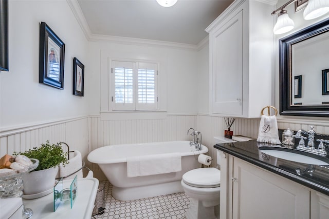 bathroom featuring tile patterned flooring, a tub to relax in, toilet, vanity, and ornamental molding