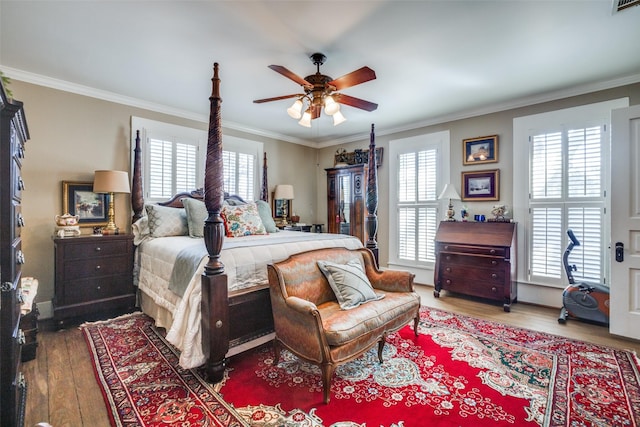 bedroom featuring multiple windows, ceiling fan, and ornamental molding