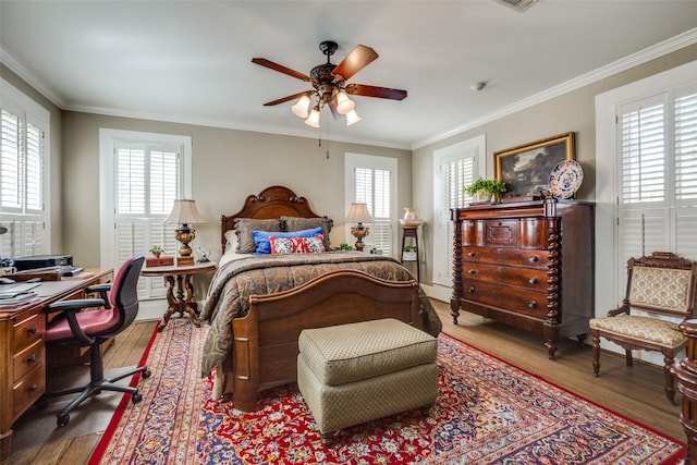 bedroom with wood-type flooring, ceiling fan, and ornamental molding